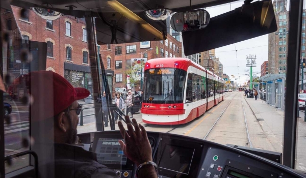 Friendly TTC streetcar drivers wave to each other in Toronto